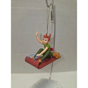 Vintage Disney Christmas ornament featuring Peter Pan riding a sled